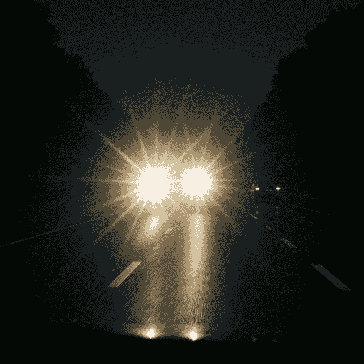 Night driving simulation showing headlight glare caused by astigmatism